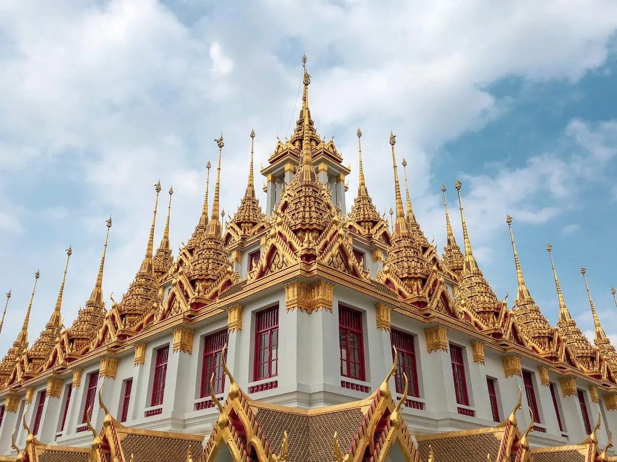 Discover the Spiritual Heart of Thailand: A Comprehensive Guide to the Temples of Bangkok 2 A captivating low angle photograph capturing the intricate architecture of Wat Ratchanatdaram Temple in Bangkok, Thailand