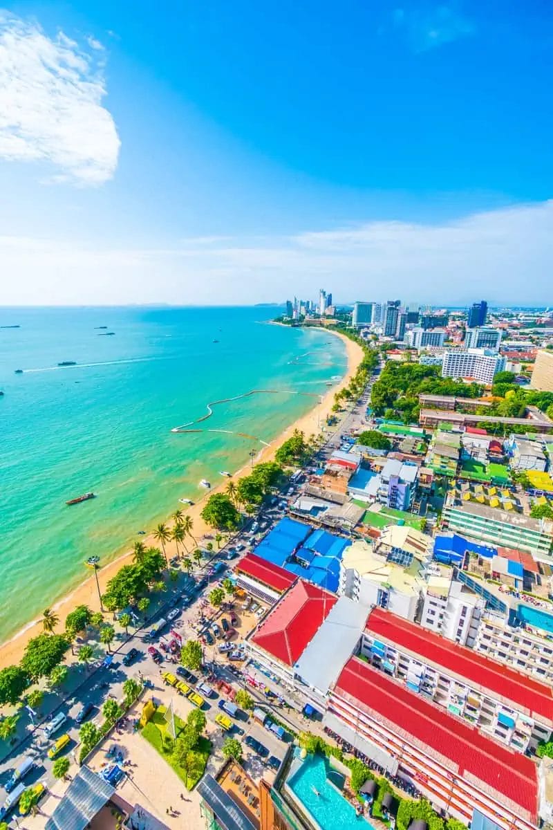 Aerial view of Pattaya cityscape and coastline under a clear blue sky