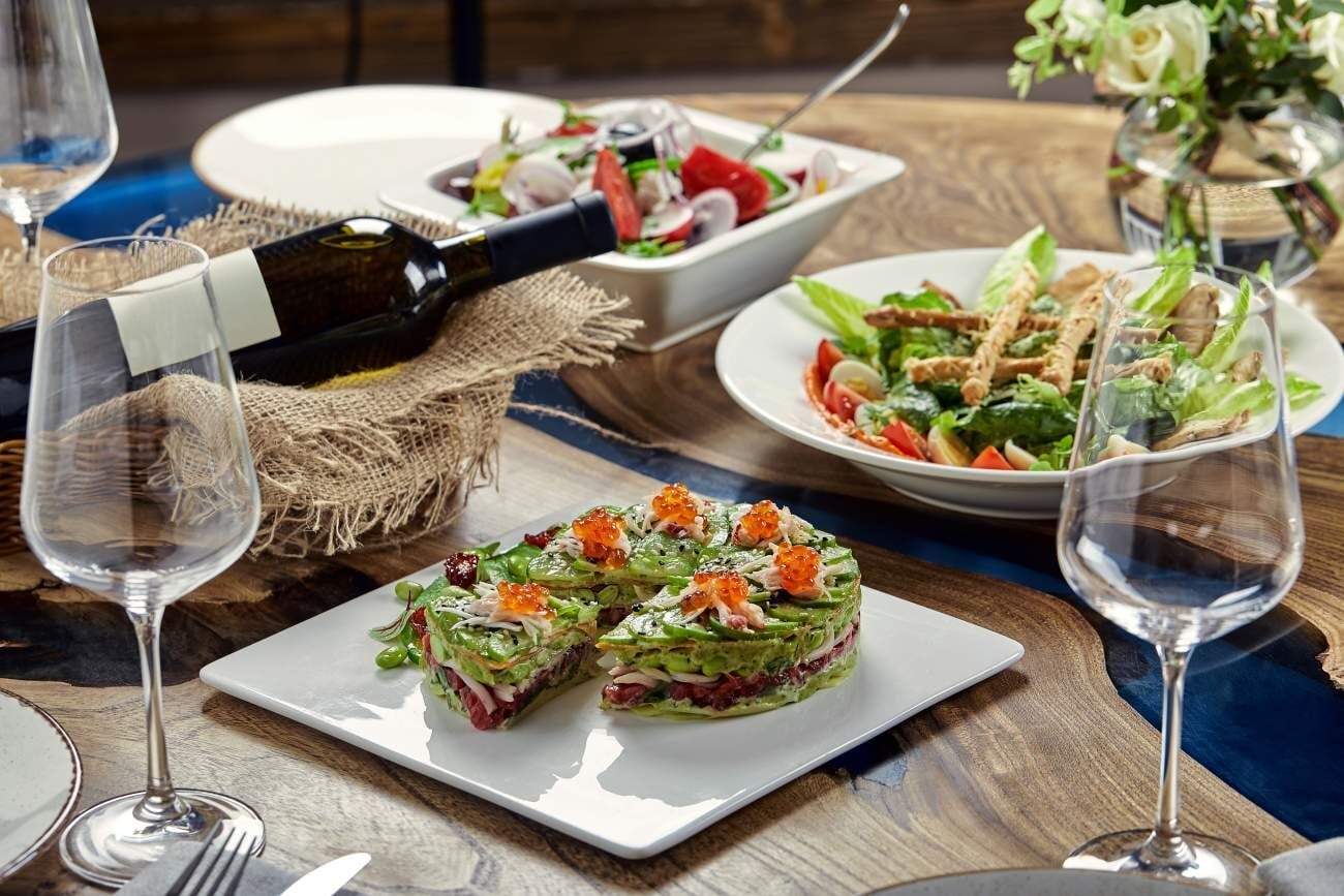 Elevate Your Dining Experience: Michelin Star Restaurants in Bangkok 1 Avocado, seafood, meat, and vegetable salad with pumpkin seeds. A nutritious and delicious gourmet dish, perfect for festive occasions. Presented on a white background