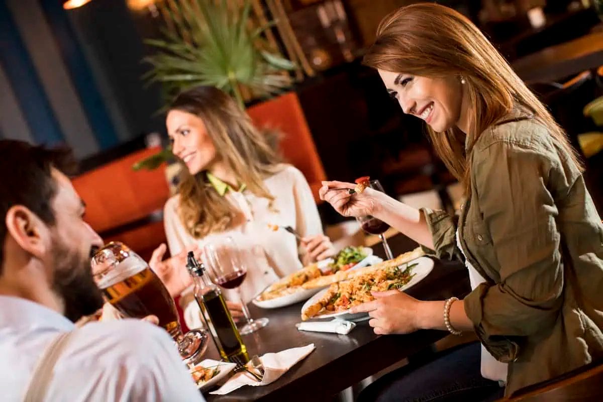Top Italian Restaurants in Pattaya: A Culinary Journey Through Italy 1 Friends enjoying a meal and conversation at an Italian restaurant