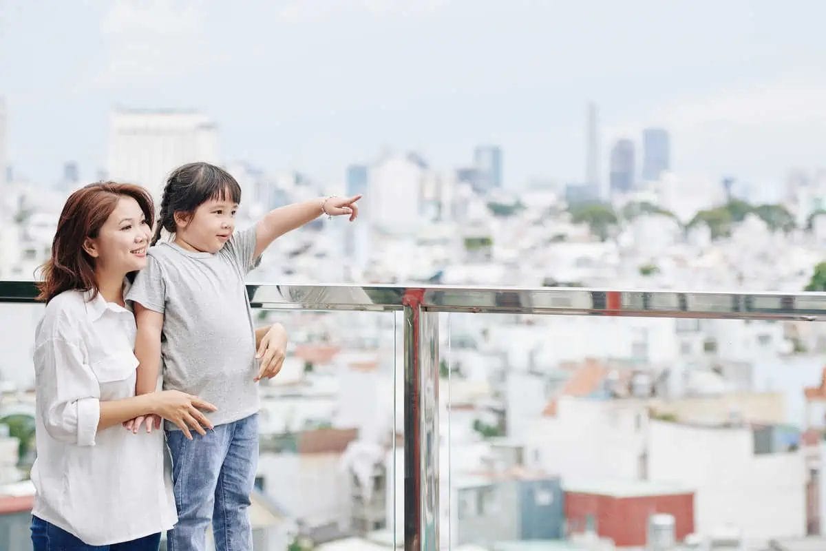 Mom and Daughter Admire City View Together