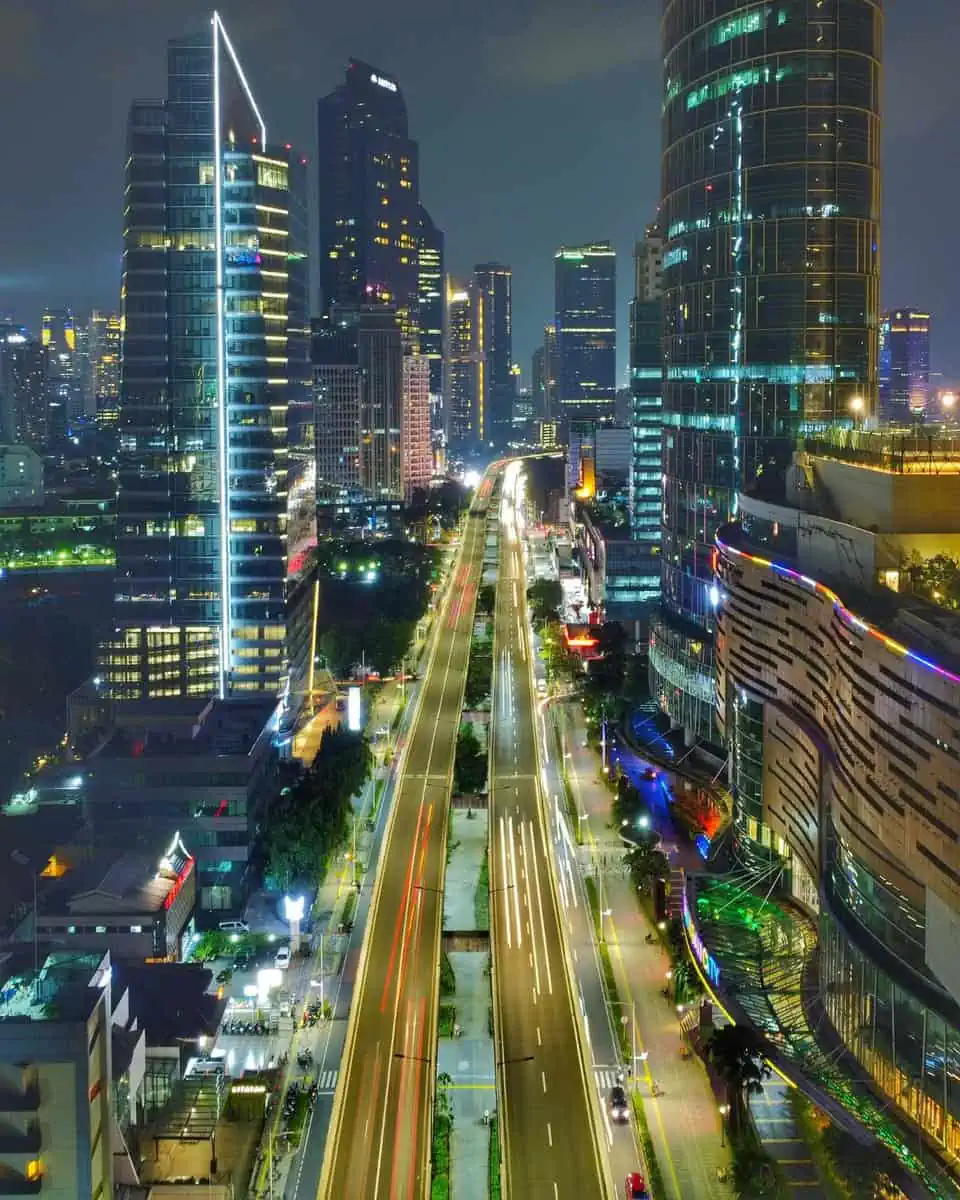 Night view of a brightly lit Bangkok city with busy streets