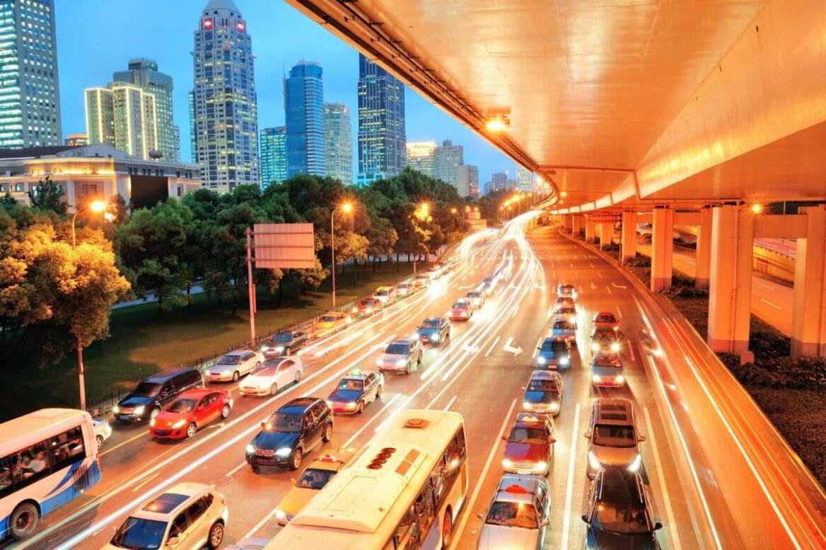 Street view of Bangkok at dusk, capturing the urban scene and busy traffic
