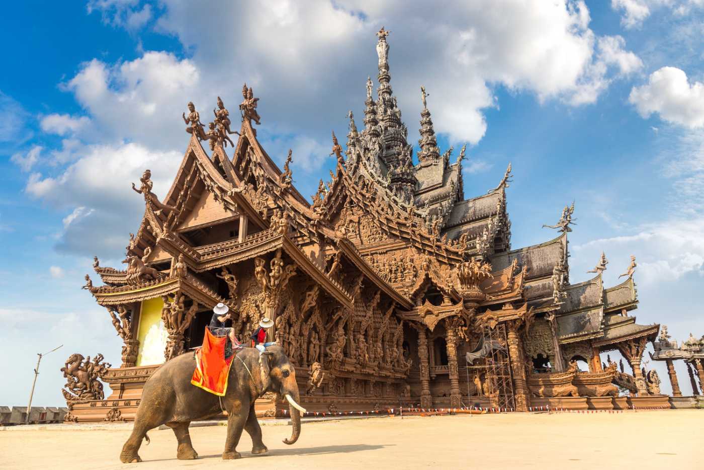 Striking image of Pattaya's Sanctuary of Truth, showcasing its intricate wooden carvings and majestic architecture