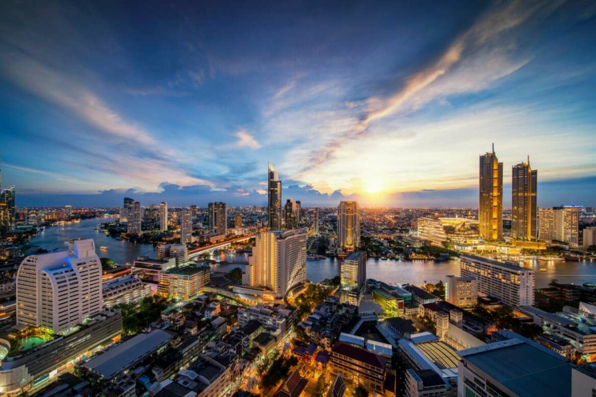 View of Bangkok’s cityscape from a hotel rooftop bar, overlooking the Chao Phraya River